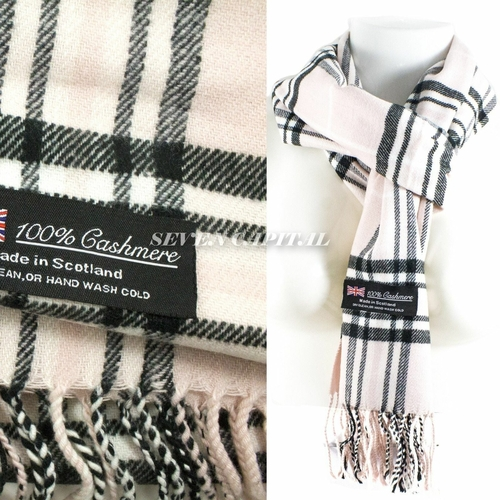 Plaid cashmere scarf with label detailing material and care instructions, on a white background.