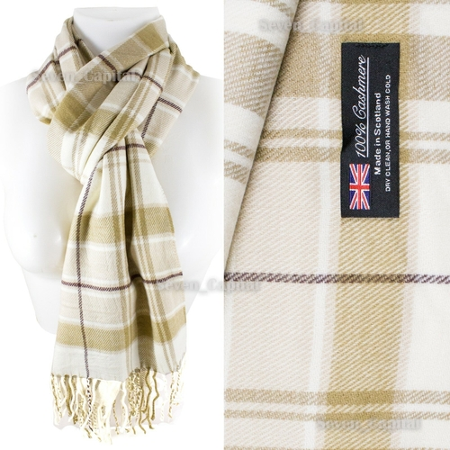 A plaid scarf displayed on a white mannequin torso and shown in a close-up fabric detail. The scarf has a cream and beige base with tan and brown plaid stripes and fringed ends.