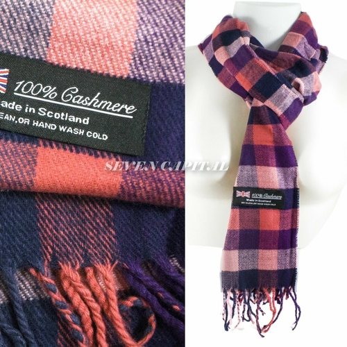 Plaid cashmere scarf with label indicating 100% cashmere and made in Scotland, on a white background.