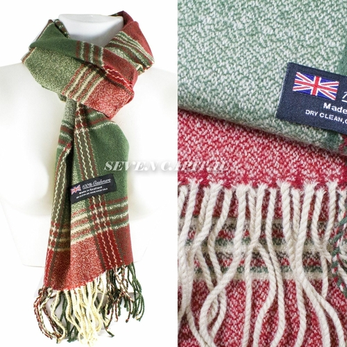 Green and red plaid scarf on a mannequin with a close-up of the fabric showing fringes and a label.