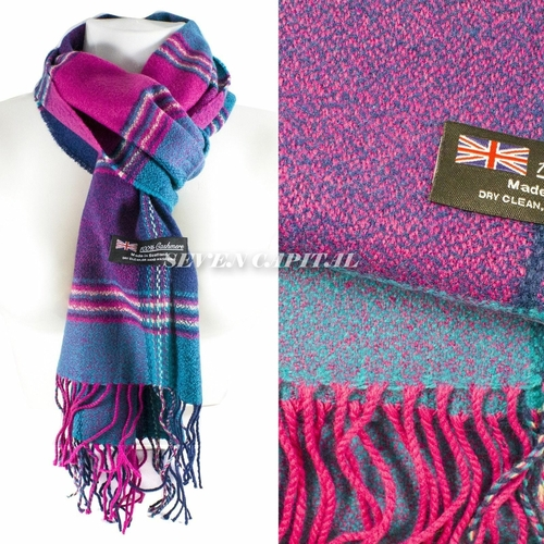 A multicolor knit scarf with pink, purple, and blue tones, shown draped on a white mannequin torso and in a close-up detail view. The scarf has fringed ends and a sewn-in label reading 'Made in UK' with a Union Jack flag.