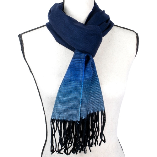 Blue scarf with black fringe on a mannequin against a white background