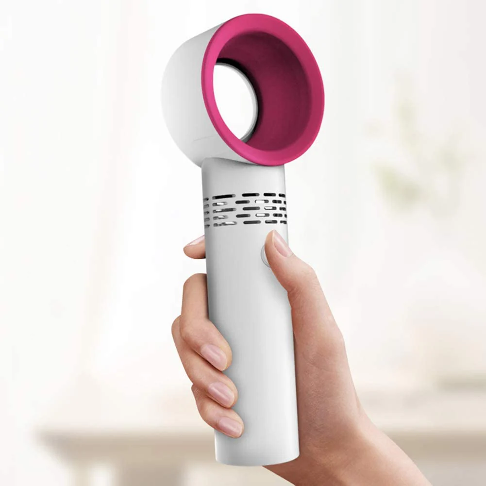 Hand holding a white and pink handheld device against a blurred background