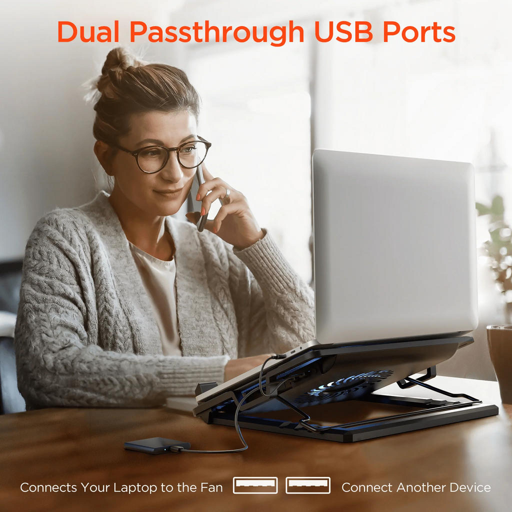 Woman using a laptop with a dual passthrough USB ports feature, sitting at a desk.