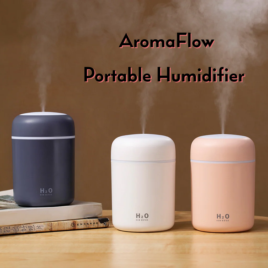 Three portable AromaFlow H2O humidifiers in navy blue, white, and blush pink, shown with mist emitting from the top on a wooden table against a warm brown background.