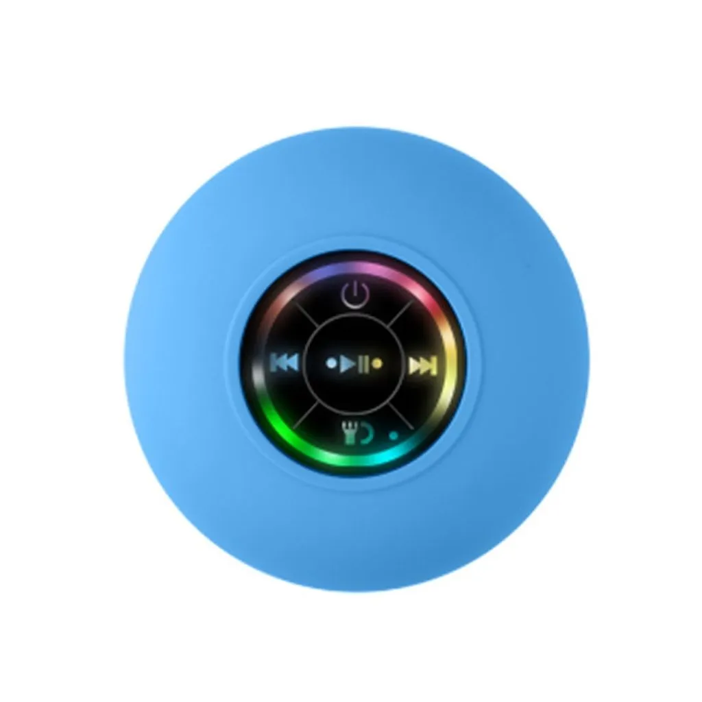 A round blue portable Bluetooth speaker with a central control panel showing music player icons and a colorful LED ring, isolated on a white background.