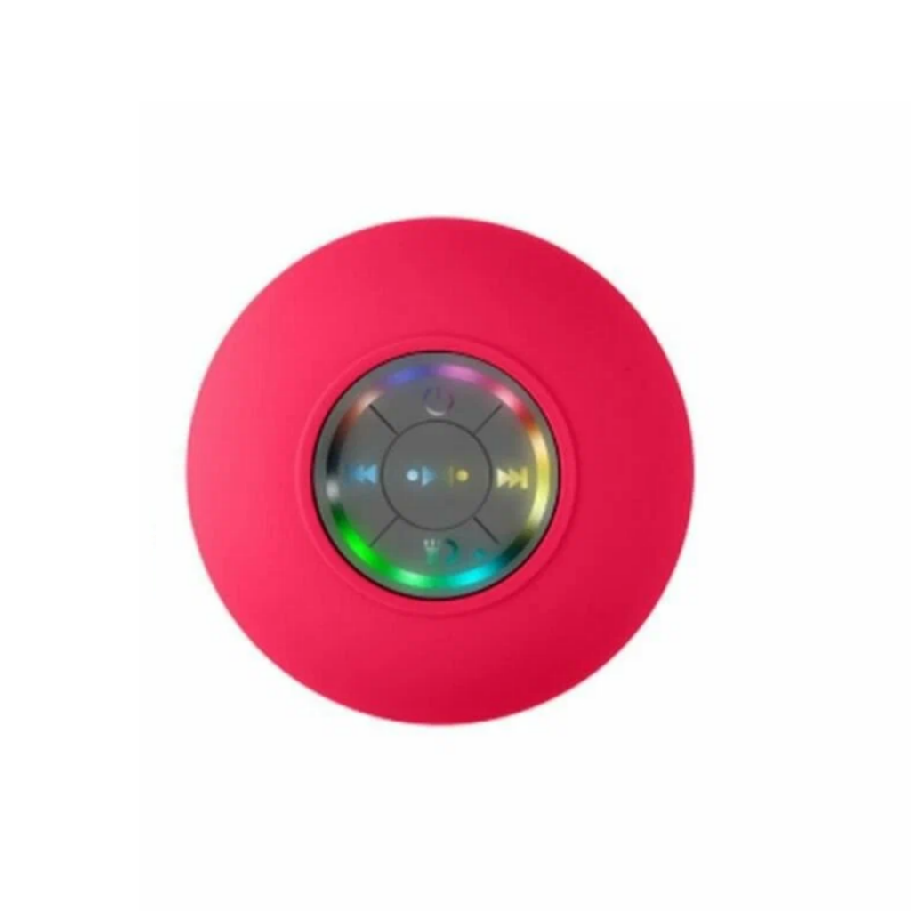 A round, bright pink portable Bluetooth speaker with a glossy center control panel showing play, pause, and skip icons, isolated on a white background.