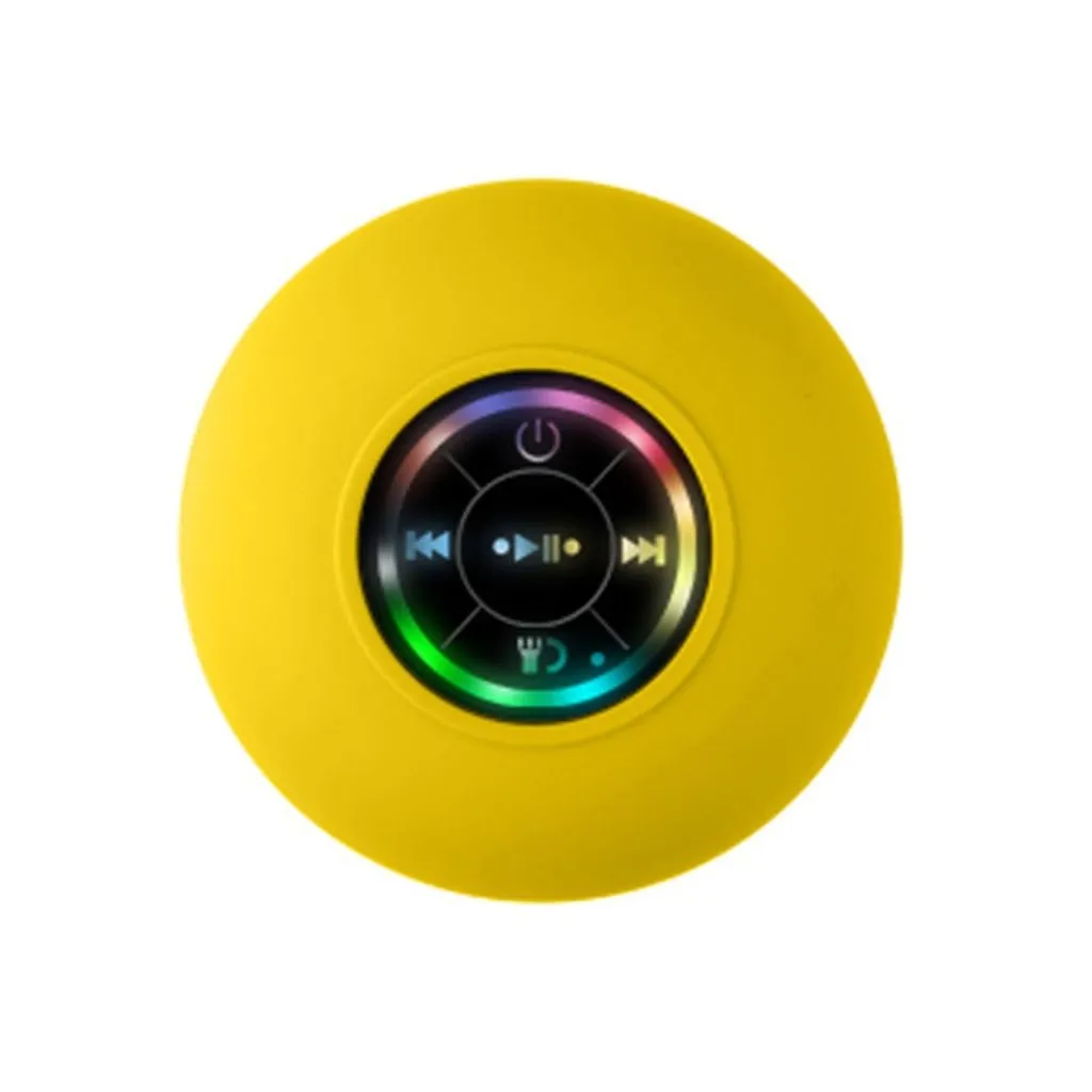 A round yellow portable speaker with a central black control panel featuring colorful LED lighting and playback icons, isolated on a white background.