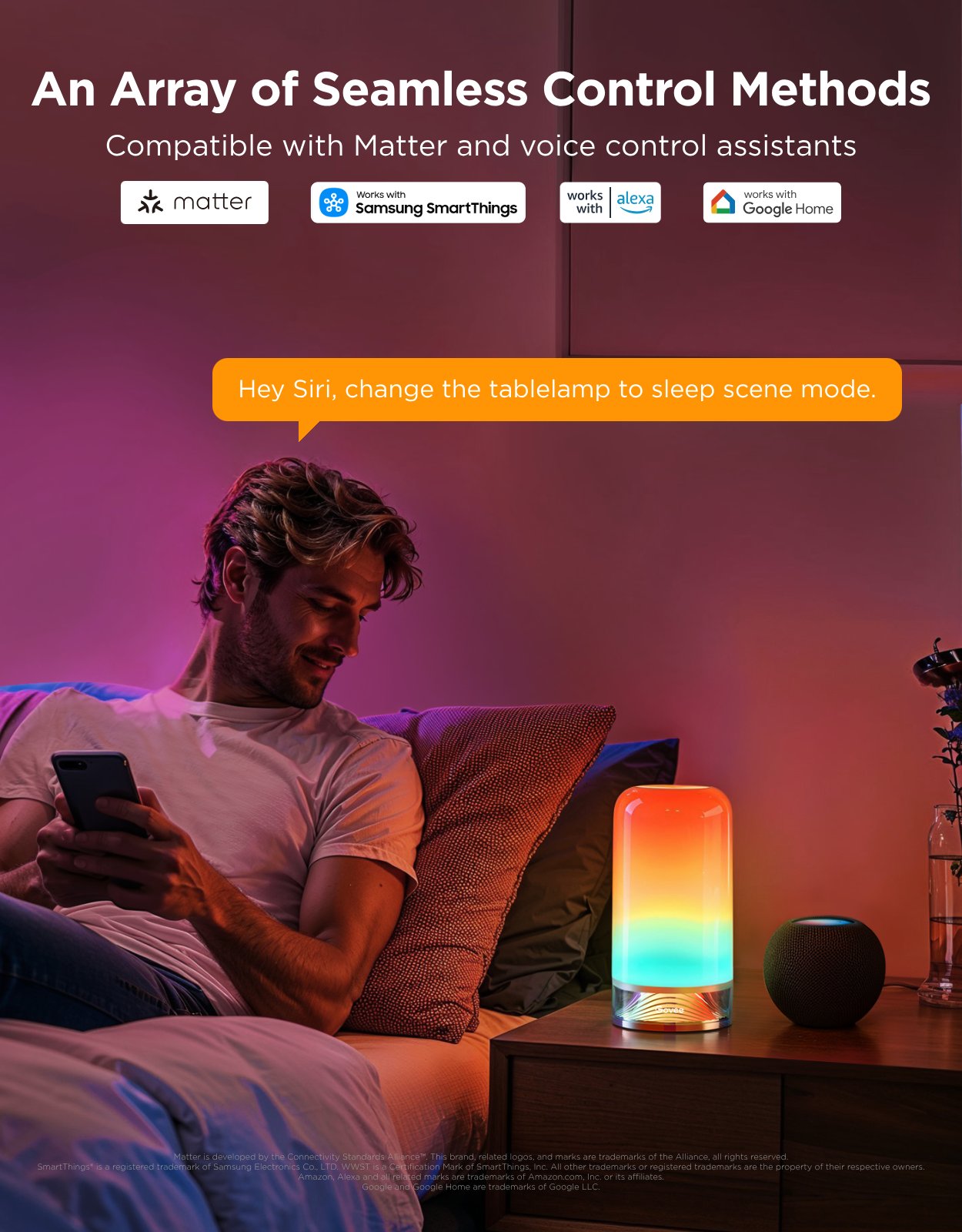 A man reclining on a bed in a bedroom, looking at a phone while a colorful LED table lamp glows on the bedside table. Text at the top reads 'An Array of Seamless Control Methods' with Matter, Samsung SmartThings, Alexa, Google Home, and Siri compatibility logos, plus an orange speech bubble saying 'Hey Siri, change the tablelamp to sleep scene mode.