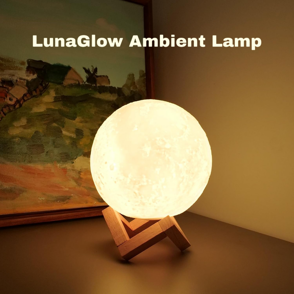 A glowing spherical moon lamp on a small wooden stand, placed on a tabletop in front of a framed landscape painting. The text 'LunaGlow Ambient Lamp' appears at the top.