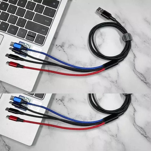 Multifunctional cable with USB connectors on a marble surface next to a laptop.