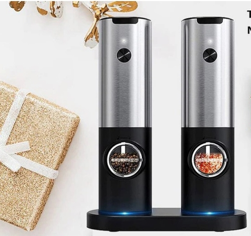 Two electric wine bottle openers on a white surface with decorative elements.
