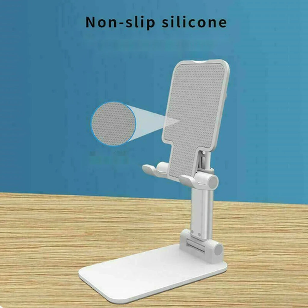 A white adjustable phone stand with a textured non-slip silicone panel, shown on a wooden surface against a blue background. Text at the top reads 'Non-slip silicone' with a magnified inset circle highlighting the textured surface.