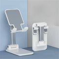 A white and silver adjustable desk stand shown in two positions: one unfolded with a tilted screen angle and one folded flat against a blue and gray background.