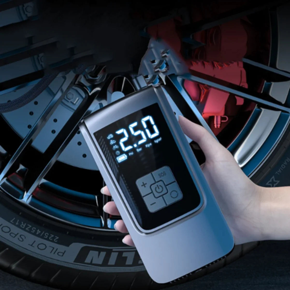 Hand holding a digital tire pressure gauge in front of a car tire.