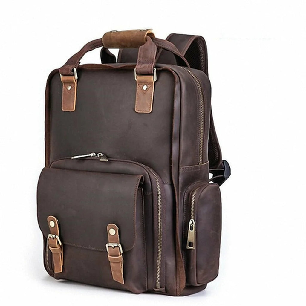 Brown leather backpack with multiple pockets and straps on a white background