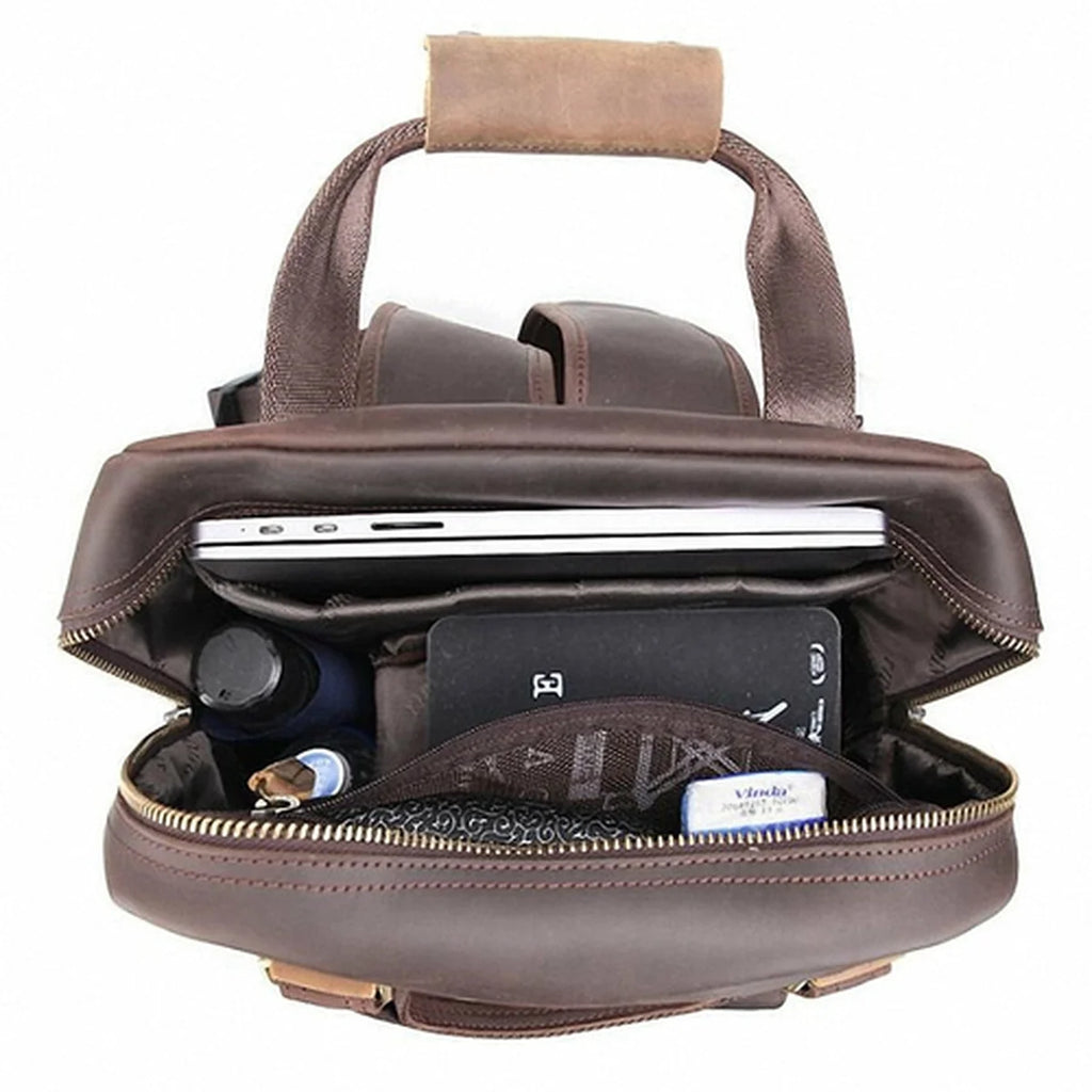 Brown leather briefcase with items inside on a white background