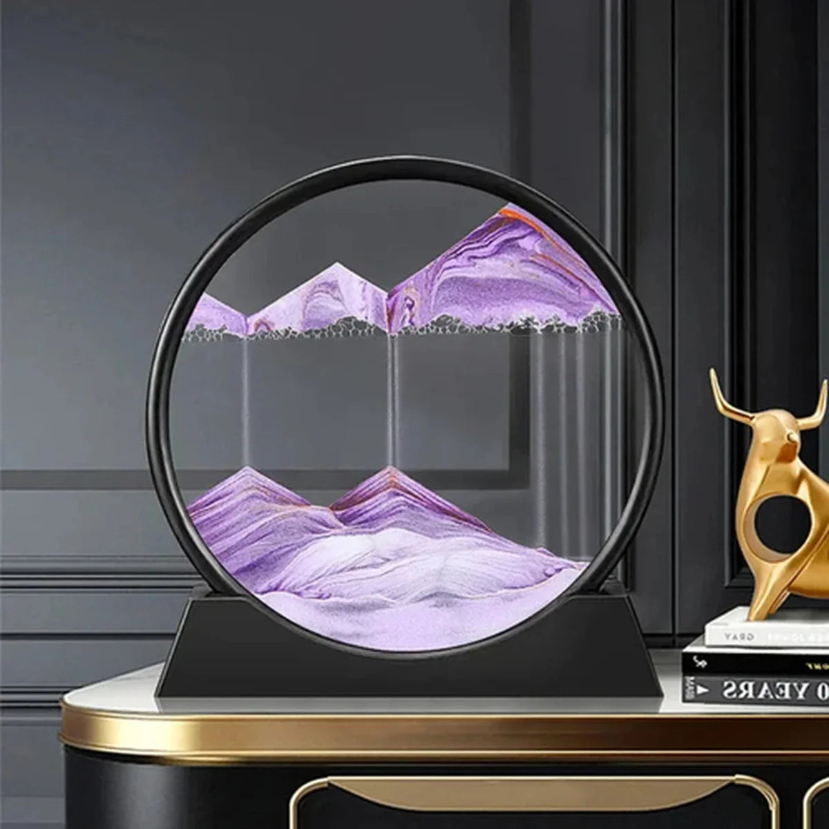 Decorative piece with purple mountain design on a black stand against a dark background