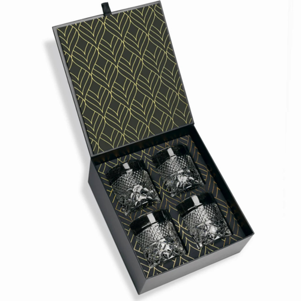 Set of four glass tumblers in a black and gold patterned box.