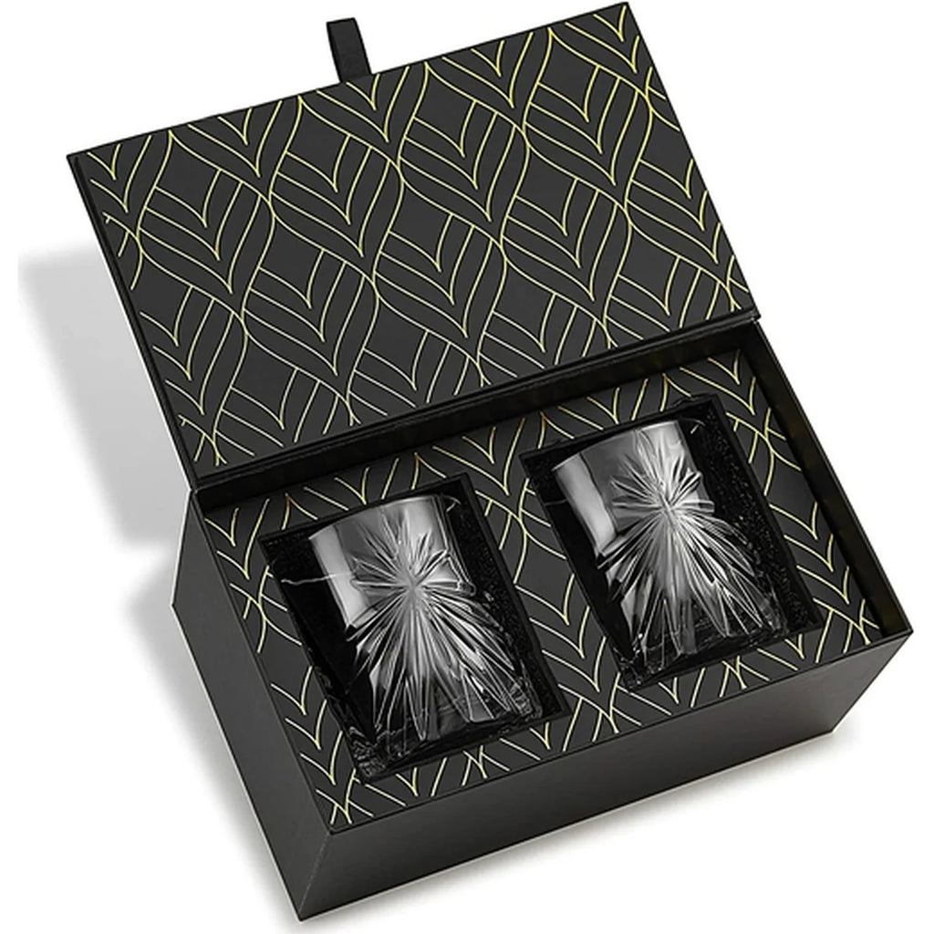 A pair of dark gray textured glass tumblers presented in an open black gift box with a gold leaf pattern on the interior lid and base.