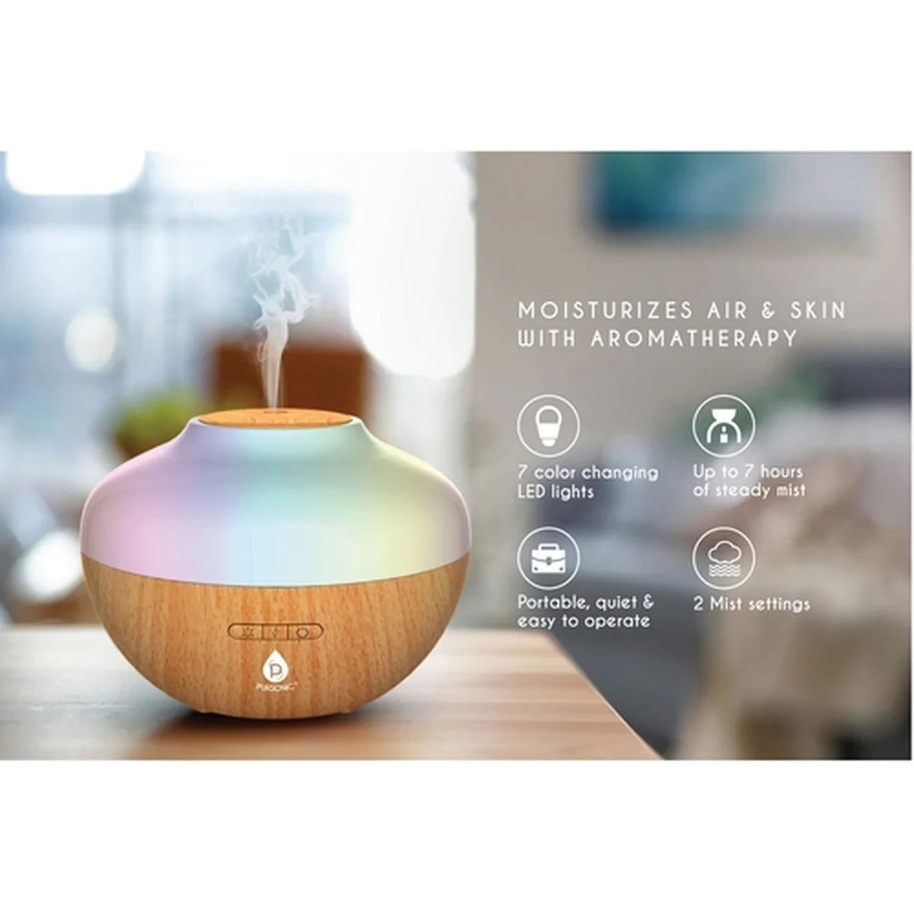 Aromatherapy diffuser with color-changing LED lights on a blurred background