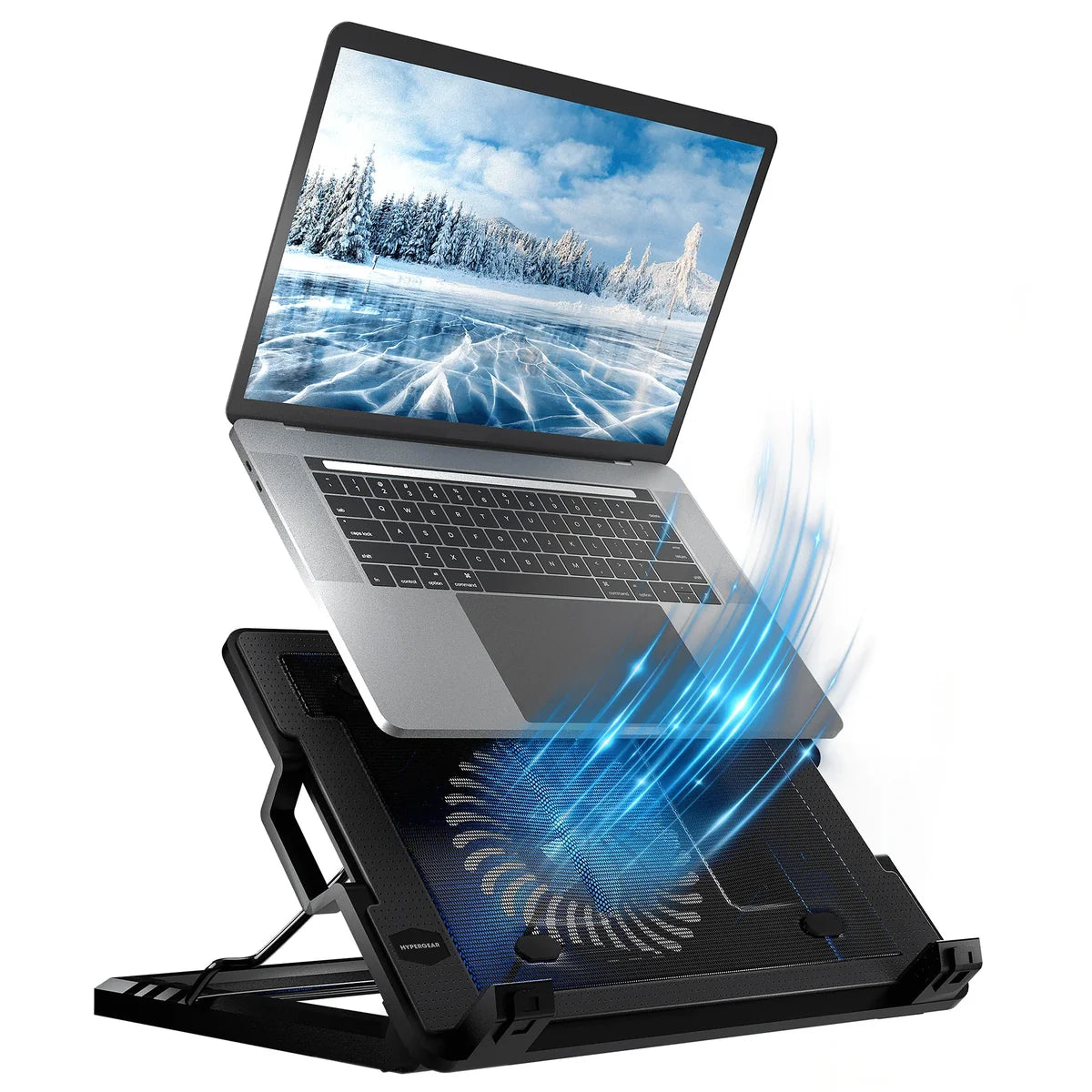 Laptop on a cooling stand with fan blowing air, screen displaying a snowy landscape.
